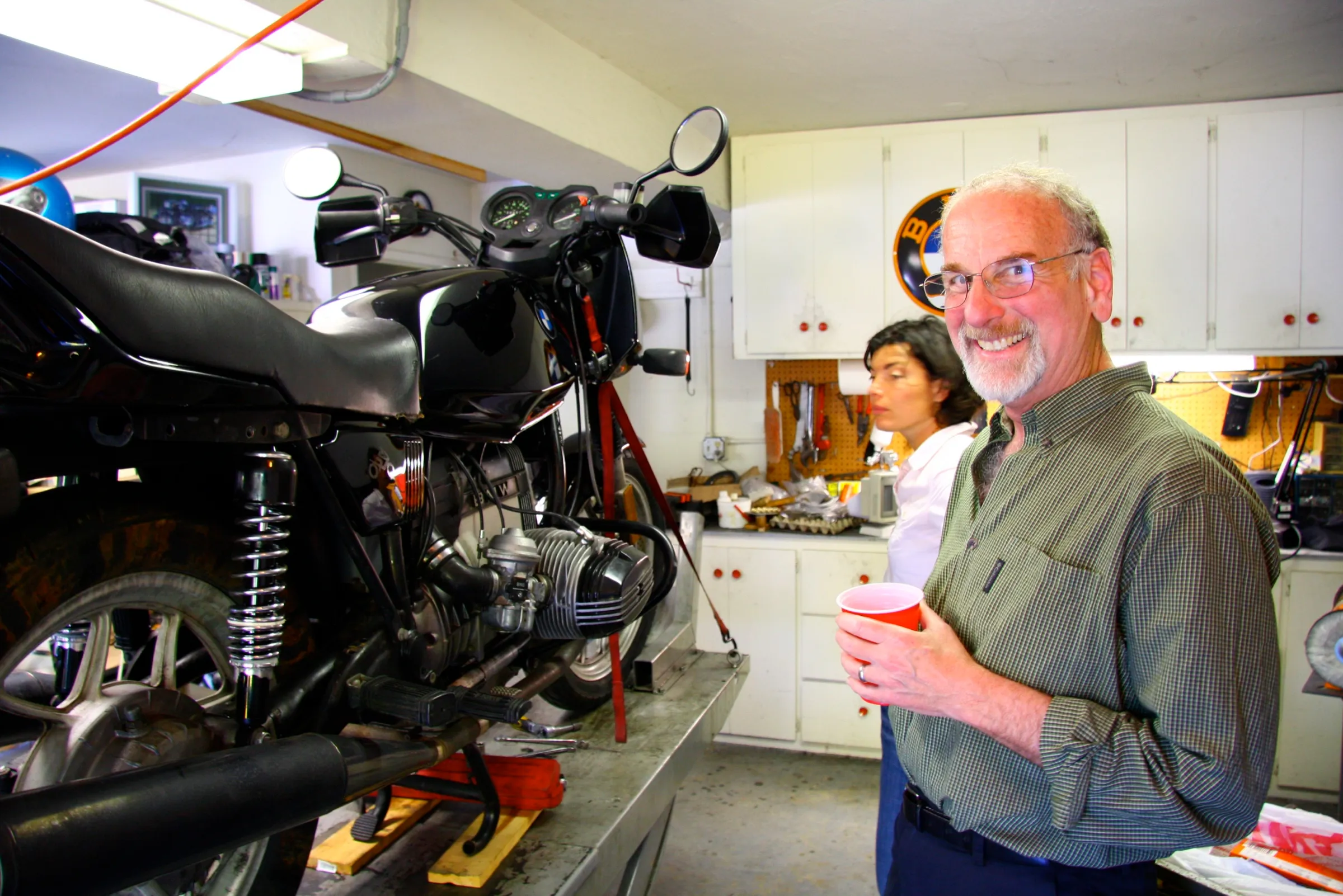 David Brick smiles as Sophie waits in the background for Greg to show her how to adjust her valves
